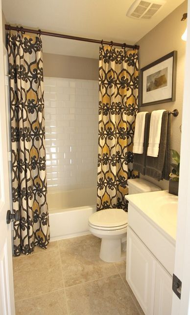 Bathroom Curtains. Use regular curtains and take rod to the ceiling.