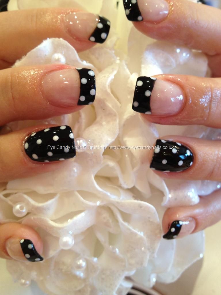 Black polish with white polka dot nail art