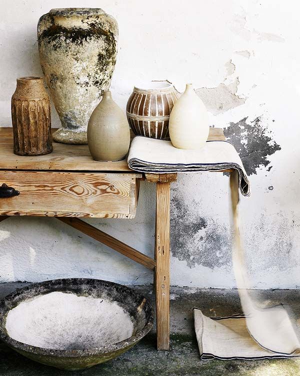 Rustic vignette.. I believe that is an awesome concrete bowl on the floor. Total