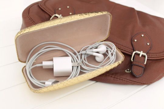 Use a sunglasses case to store cords and cables in your bag!