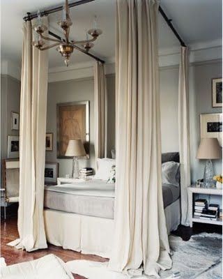 hanging curtains from the ceiling creates the look of a canopy bed – very cool!
