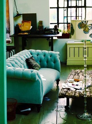 Aqua velvet Chesterfield sofa!  I like the butterfly lamp as well… (; and the