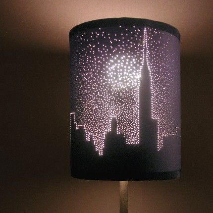 Poke small holes in a dark lampshade to make a picture– LOVE THE CITY SKYLINE!