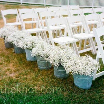 baby’s breath in tin pots lining the aisle – perfect for a casual outdoor ceremo
