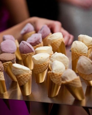 mini ice cream cones wrapped in gold paper… serve to guests after wedding cake