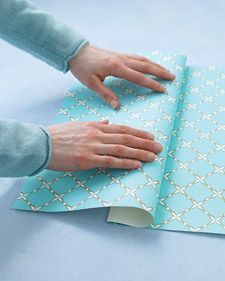 Fold a pocket in your wrapping paper to put the card in it .