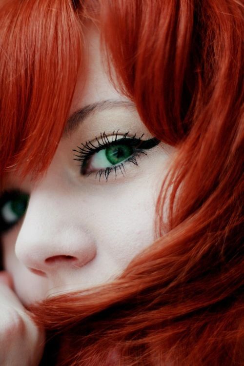 Red hair and green eyes.