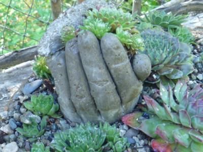 Hand planters! Fill old work gloves with cement, let harden and cut away gloves.