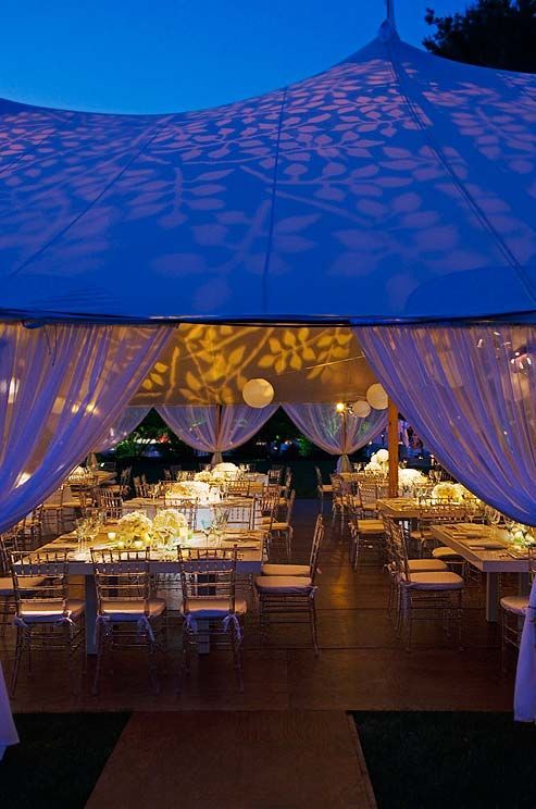 A leaf pattern projected onto the roof of the tent casts a warm glow over the re