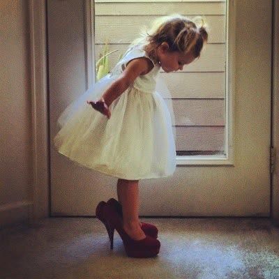 A picture of the flower girl in the brides shoes!!!