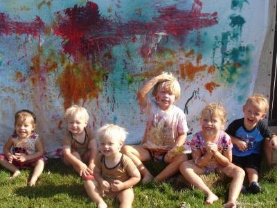 A white sheet and spray bottles with diluted paint = toddler fun & art all in on