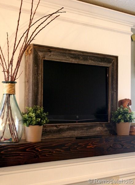 Framed TV over fireplace, great idea! Above the fireplace always seems the best