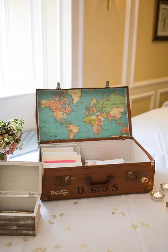 Vintage suitcase lined with vintage map to gather cards from wedding guests