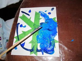 Christmas Winter Craft Kids painting over tape to make snowflake– great for any