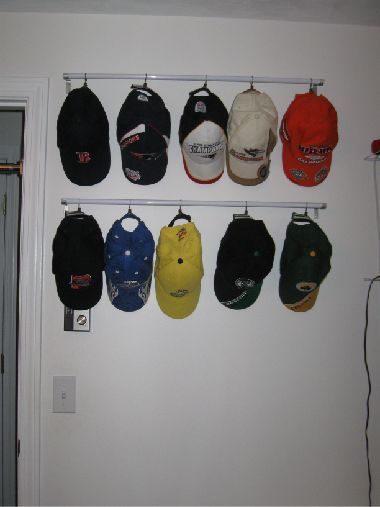 Baseball hat storage.  Cheap curtain rods with ring clips.  For Mike’s growing h