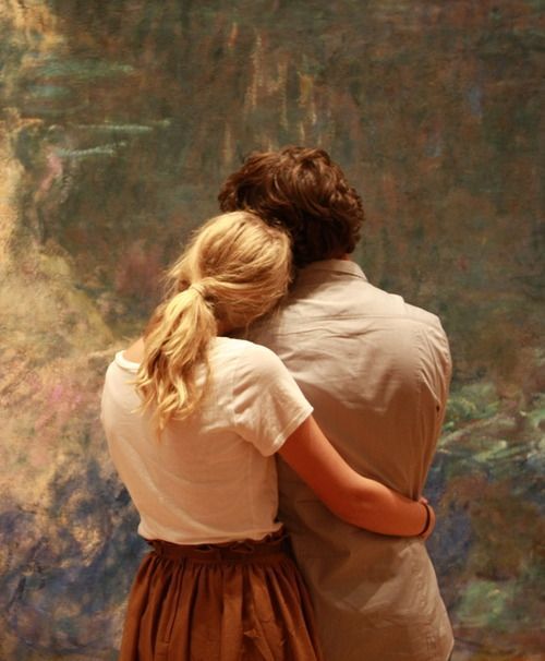 A couple admires the color and texture of Monets Water Lilies at MoMA, New York