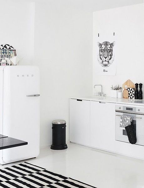black and white kitchen with a SMEG fridge.