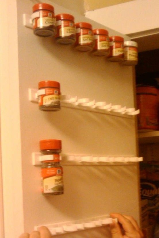 Forget the spice rack!!  Use a mop holder to store spices on the inside of a cab