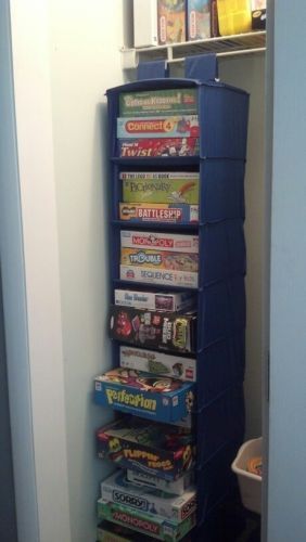 Store and organize board games in a hanging shoe organizer. Never thought of thi