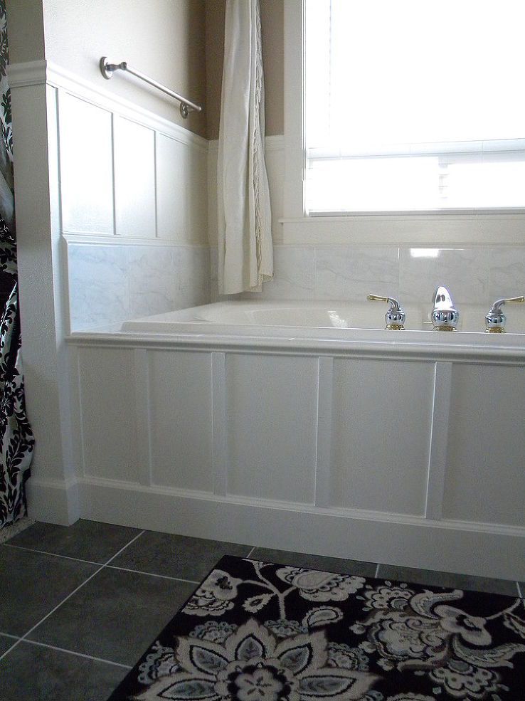 updated 90s bathtub in one weekend with less than $200, using marble and paneling over the existing old