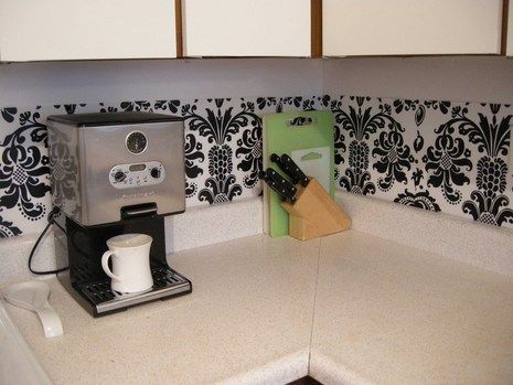 Plastic dollar store place mats as back splash. Attach w/pushpins or double sided