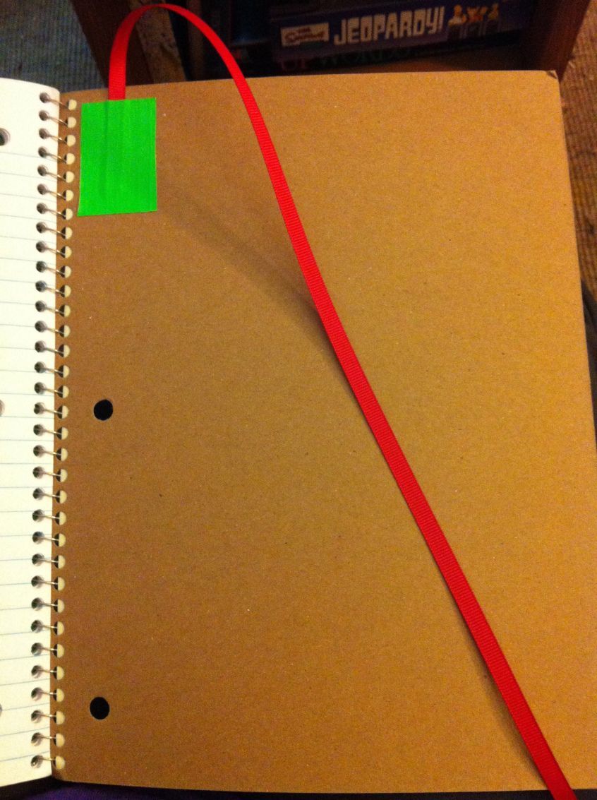 duct tape a piece of ribbon to the back of notebooks to keep place in