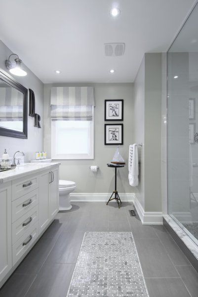 Gray tile floor with white vanity… Bathroom ideas/ love how they have the tiles that looks like the runner