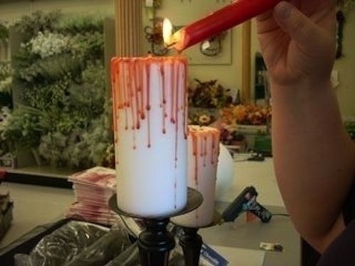 Melt a red candle over a white one for a bloody effect. | 27 Incredibly Easy Ways To Upgrade Any Halloween Party