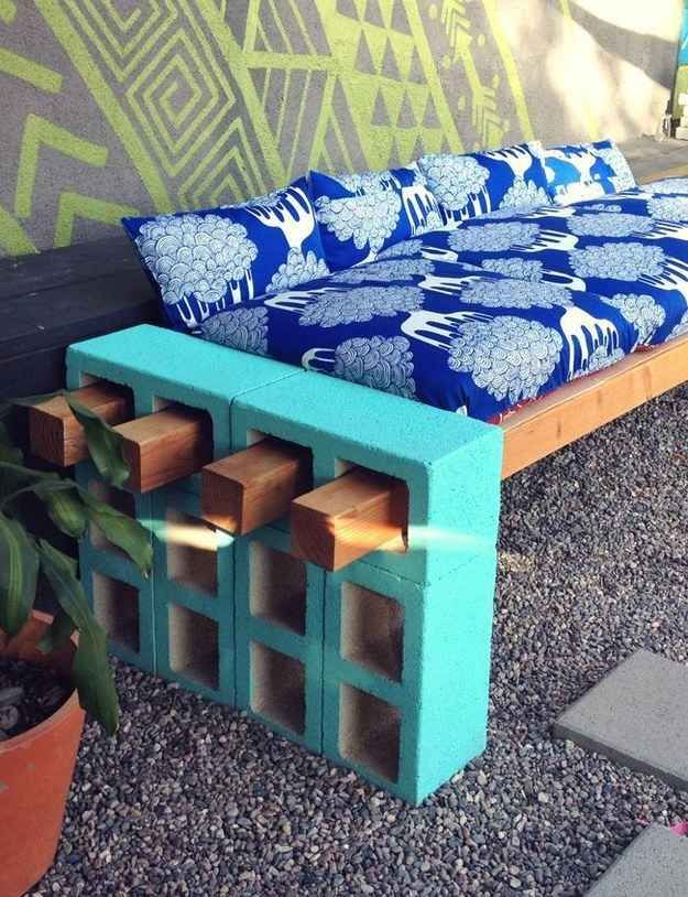With a few long pieces of wood, you can also use cinder blocks to create an impromptu couch. | 41 Cheap And Easy Backyard DIYs You