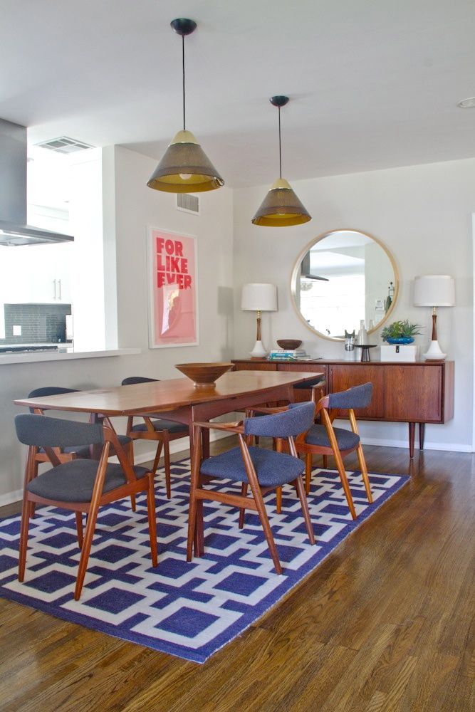 mid-century dining table, graphic rug, fantastic credenza, iconic white and walnut lamps and perfect chairs = mid century love