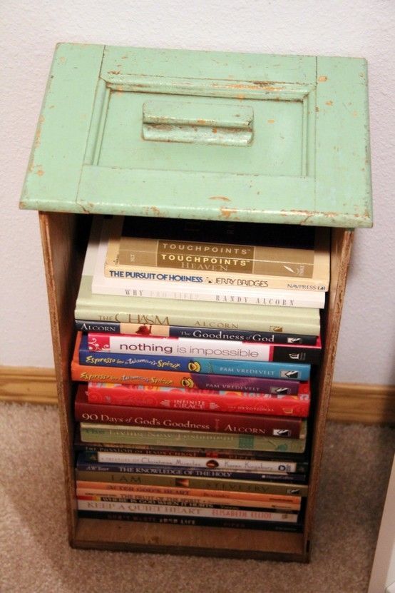 You can find old file cabinets at second hand shops for dirt cheap; makes a cute book holder, no?