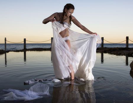 bride-ripping-off-dress-in-water / trash your wedding-dress
