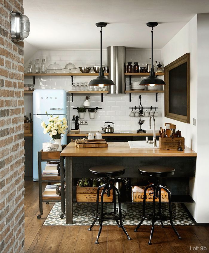 Inside an industrial loft space recently updated in Bulgaria. The space features black steel, exposed brick, dark wood and