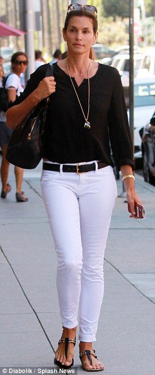 LESS IS MORE! Seasonless style: The mother-of-two looked chic in a black blouse and white skinny jeans, …