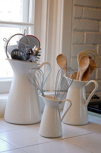 Pitchers. Cute way to organize your kitchen utensils. Then if you need a pitcher, just take the utensils out and there ya go!