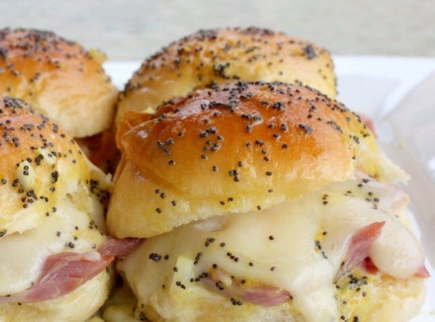 Savory fingerfood.  Melt in your mouth ham and swiss sandwiches.  Perfect for pot lucks or parties.  Definite crowd pleaser.\nVery