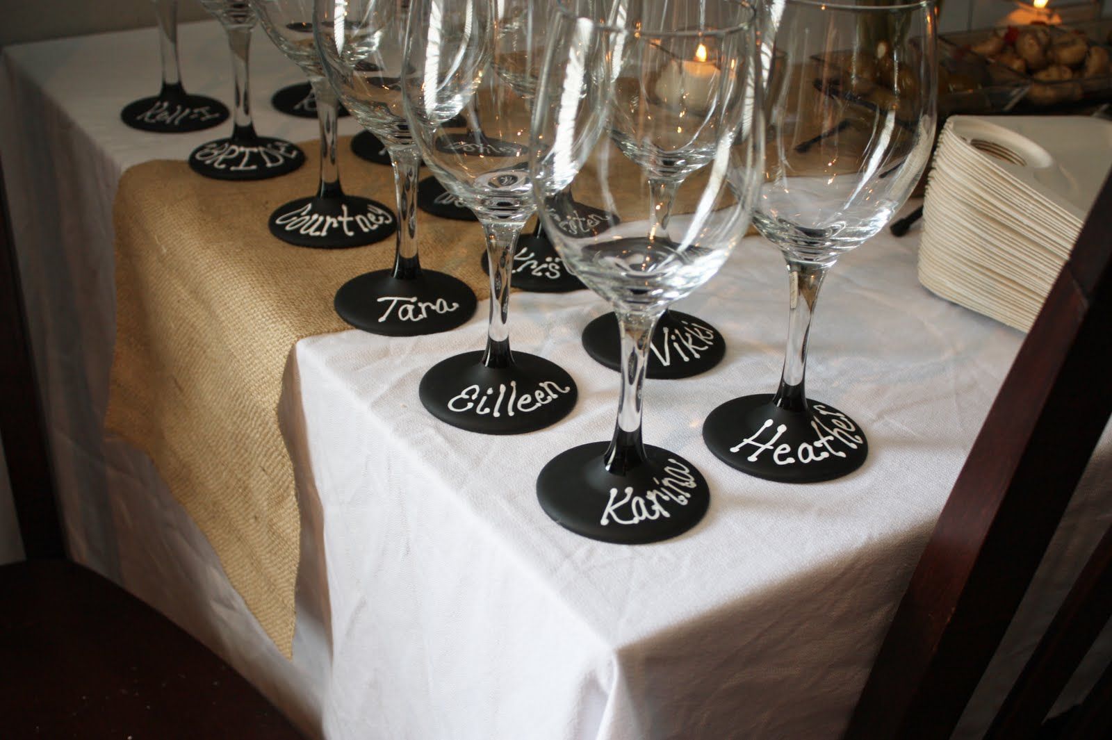 Dollar Tree $1 wine glasses painted with chalkboard paint. Perfect for this wine tasting bridal shower