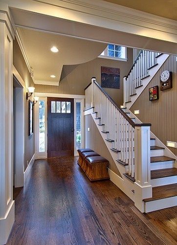 Oak floors with dark walnut stain against simple white trim, love the wall color (painted bead board)–The paint color is Sherwin