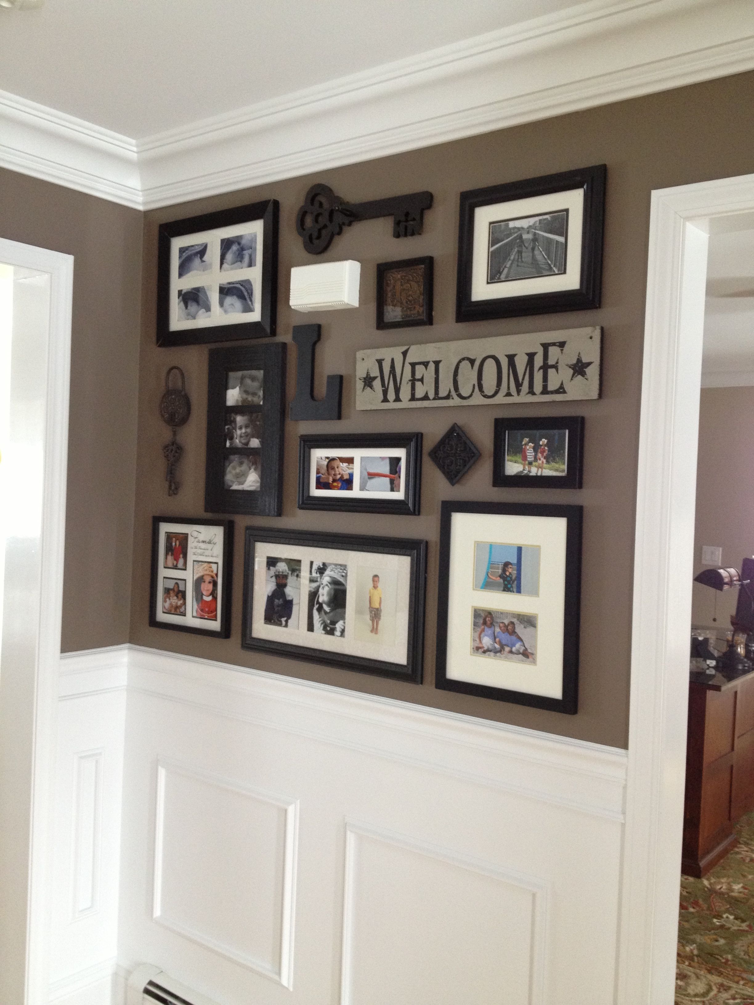 Picture collage for front entry and impressive wainscoting/crown moulding. Good paint scheme.