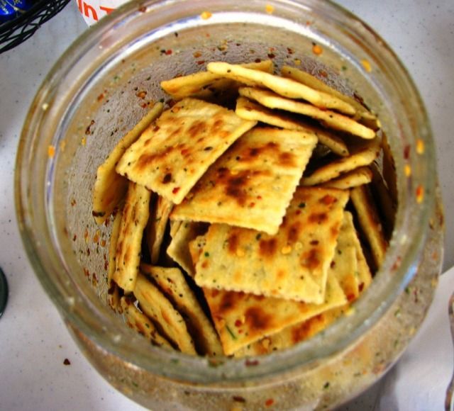 Snack Crackers -3 sleeves of saltine crackers, 1 pkg dry zesty Italian dressing, 1 pkg dry Ranch dressing,  1 T red pepper flakes,