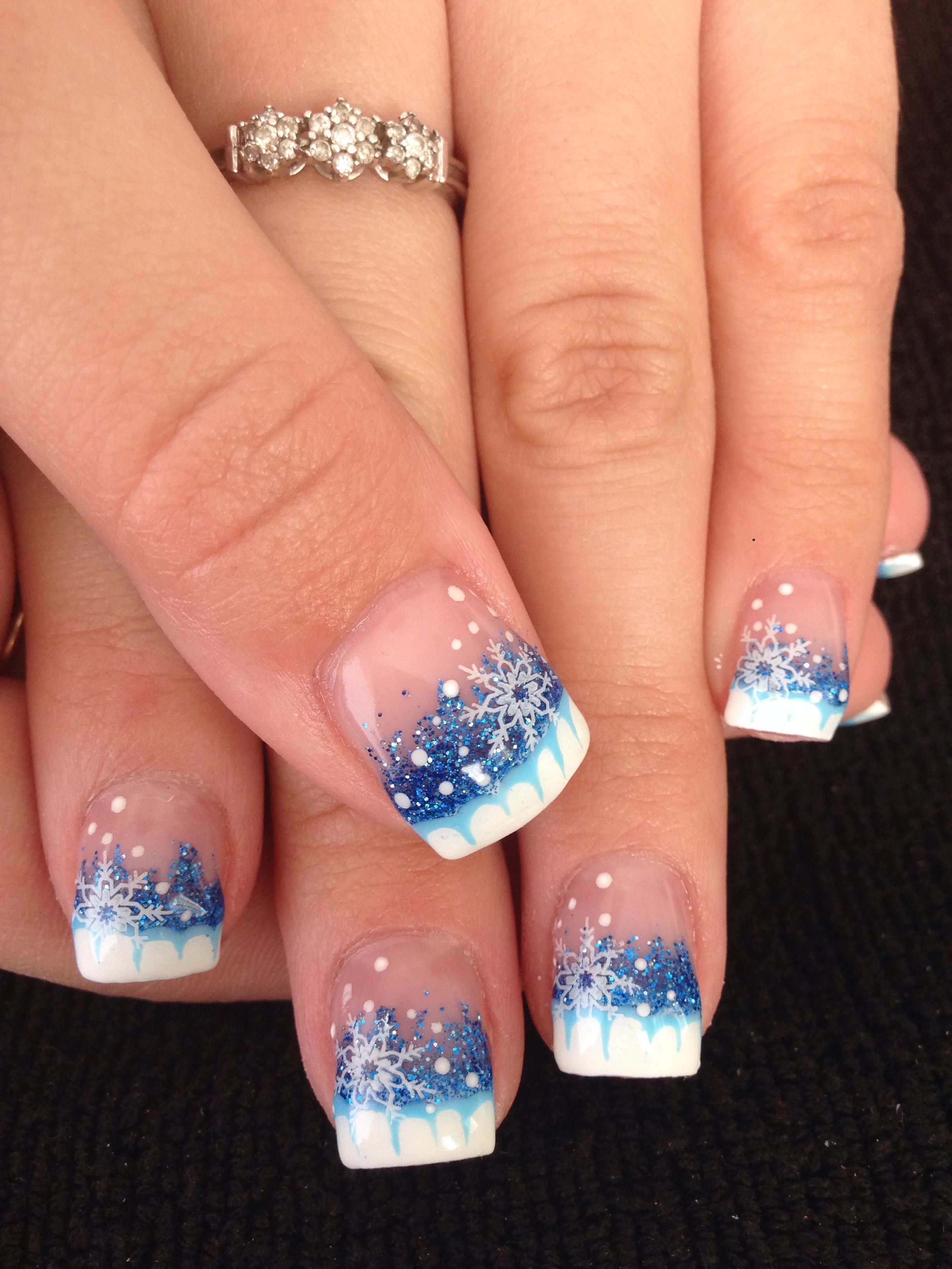 Winter gel nails with blue glitter and snowflake nail art design