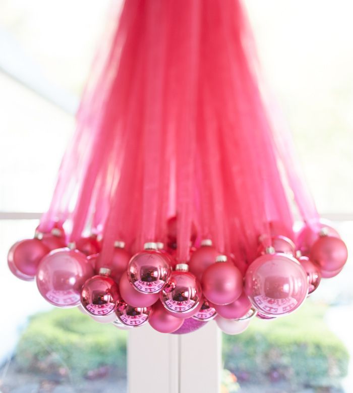 Create a gorgeous DIY chandelier for your guests to gush over using ornaments in all different sizes  and ribbon. | Setting the
