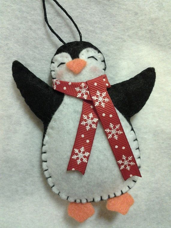 This item is a handmade felt penguin Christmas ornament. It is designed and handmade by me! I make him with either a red, blue or