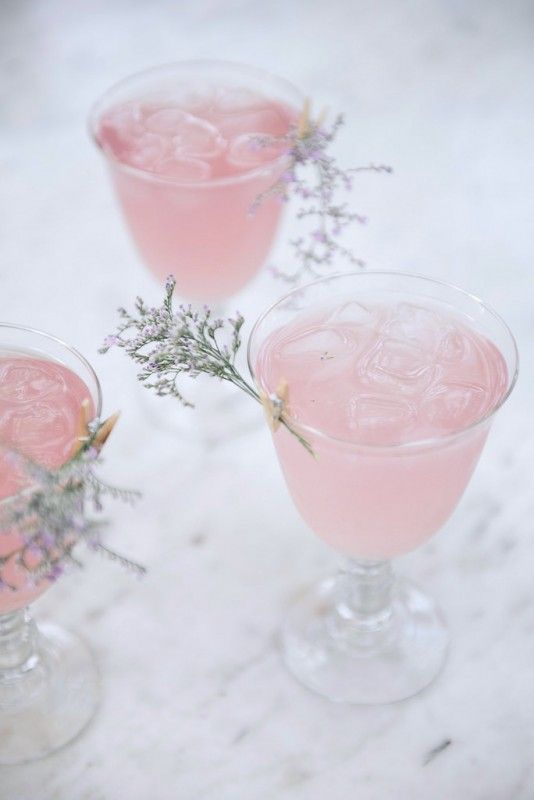Rose Water Cointreau Fizz cocktails, with a little floral garnish.