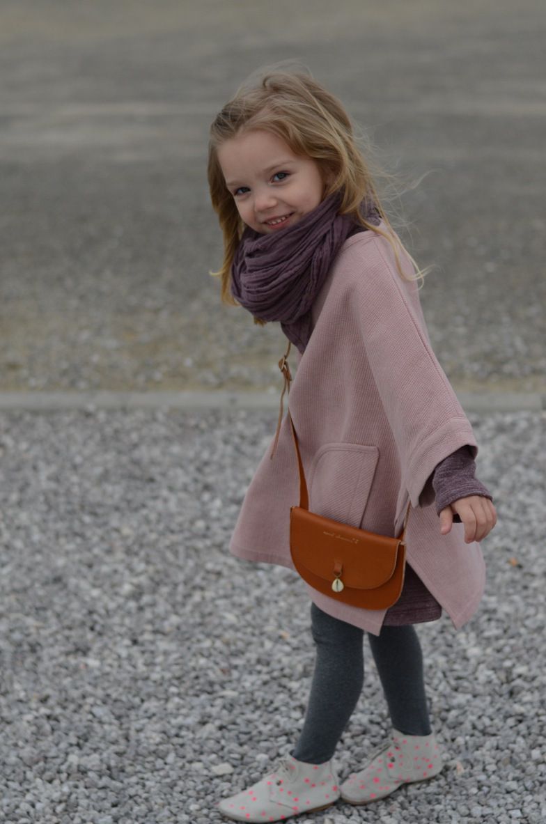This child is fabulous!! Poncho by Talc – Kaszka Z Mlekiem..Maddie will never keep this on, but it could be worth a shot!