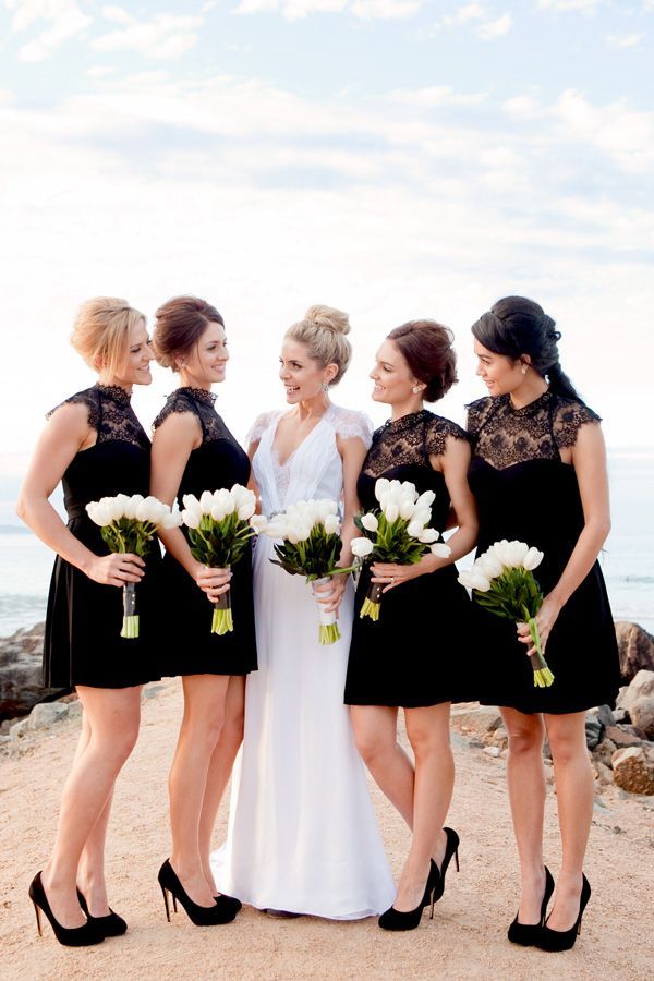 Black and white wedding – bridesmaids in black with white bouquets. Photo by Karen Buckle.