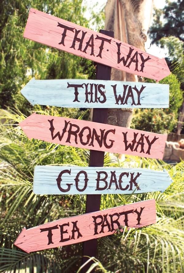 That way. This way. Wrong way. Go back. Tea party. Alice in Wonderland garden sign.