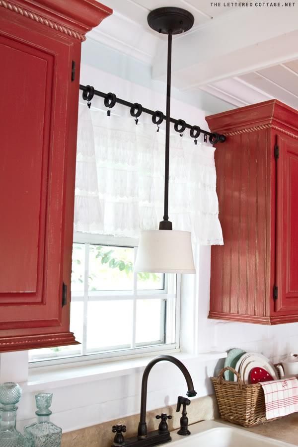 use a tension rod between two cupboards to hang a kitchen window curtain – change out your recessed light over the sink for a