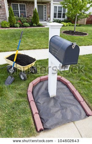 Laying Mulch Around The Mailbox And Placing Edger Bricks. Stock Photo 104602643 : Shutterstock