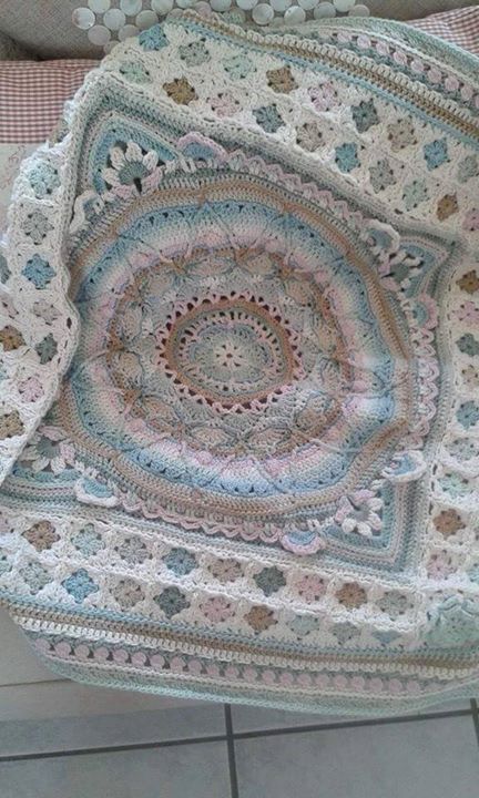 Sophie’s garden turned into afghan with small granny squares and a tulip border, beautiful by Michelle van Aardt